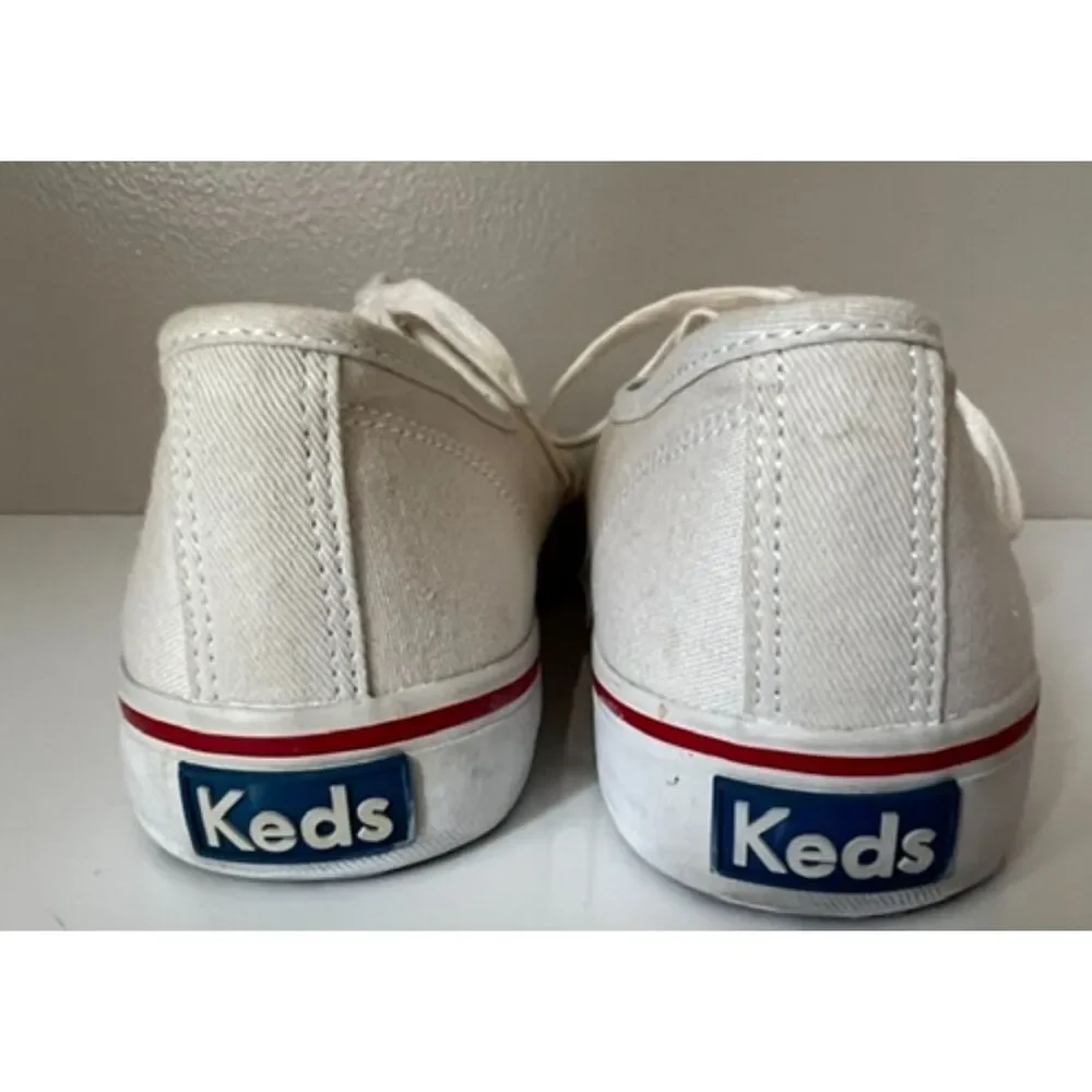 Keds low top canvas lace up sneakers with red trim. Size 8.